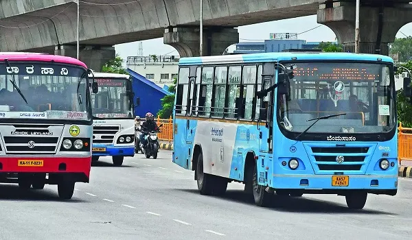 Road and bus connectivity in North Bangalore for Prestige Airport Road BMTC and KSRTC buses on a Bangalore road below a metro viaduct