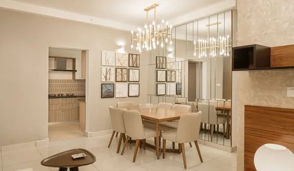Dining area with six-seater table, chandelier and mirrored wall