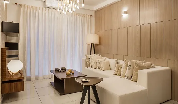 Apartment living room with white sofa, chandelier and wooden wall panelling
