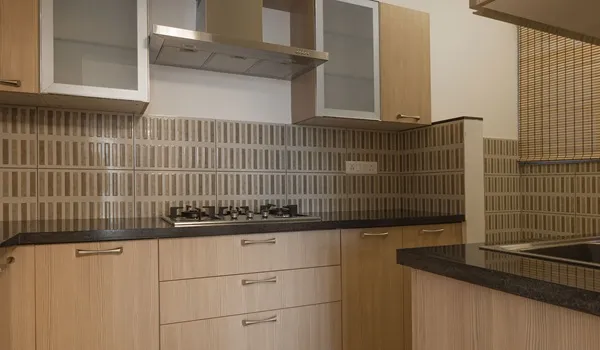 Modular kitchen with gas hob, chimney and granite counter